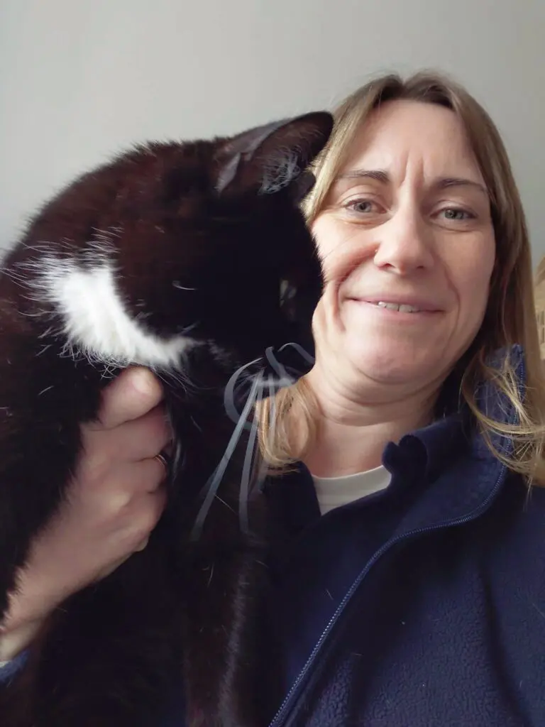 Pets 2 Places pet transport professional holding a black and white cat, representing the caring pet franchise opportunity in Solihull